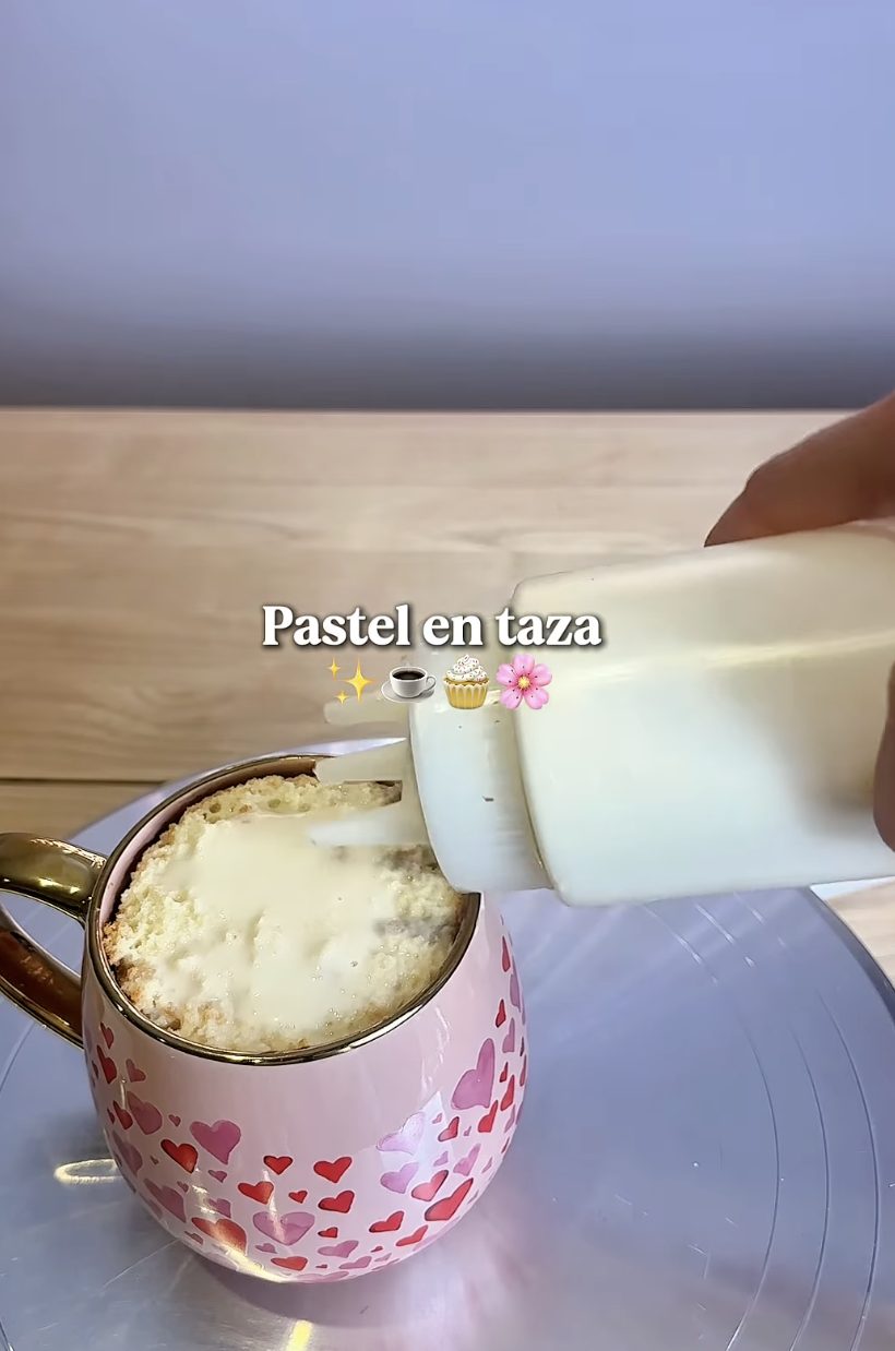 Cake in a mug being finished with condensed milk